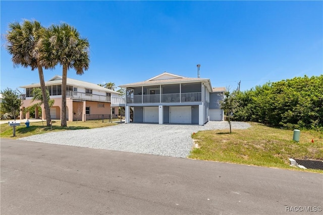 9 Flagler Dr, Palm Coast, FL 32137 - view of front facade with a garage, gravel driveway, and a balcony