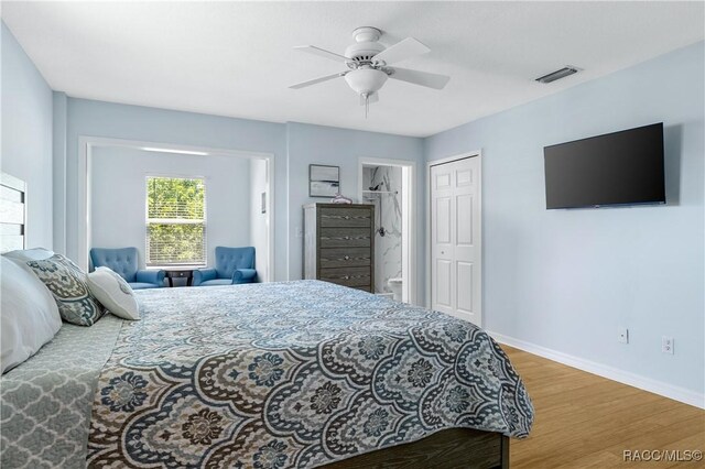 9 Flagler Dr, Palm Coast, FL 32137 - bedroom featuring wood finished floors, baseboards, a closet, ceiling fan, and connected bathroom