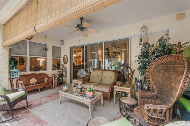 sunroom featuring ceiling fan