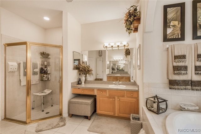 bathroom featuring tile patterned flooring, vanity, and plus walk in shower