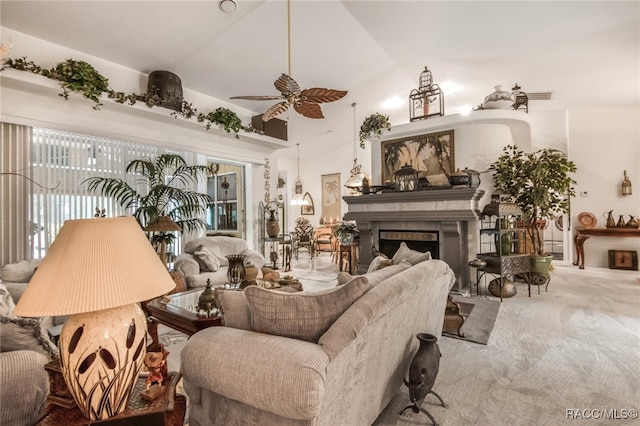 carpeted living room with ceiling fan and lofted ceiling