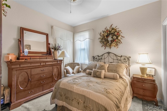 bedroom featuring light colored carpet and ceiling fan