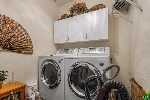 clothes washing area with cabinets and independent washer and dryer