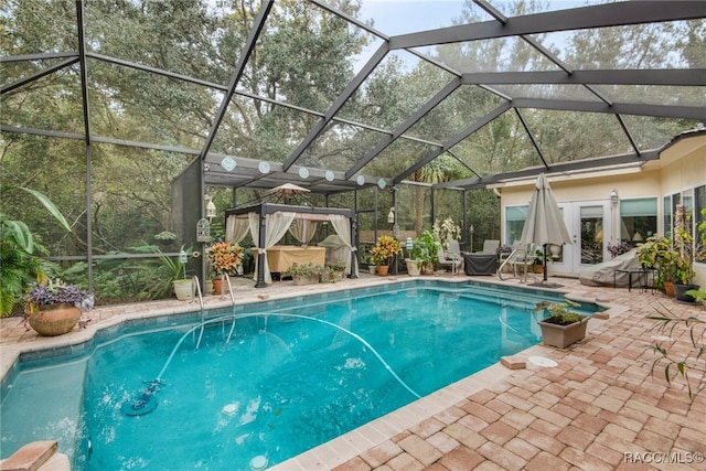 view of swimming pool with a jacuzzi, a lanai, and a patio area