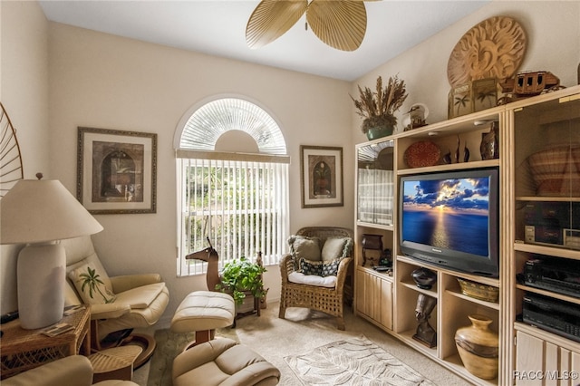 sitting room with ceiling fan and light carpet