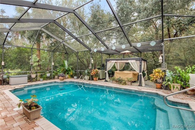 view of pool with a patio area and a lanai