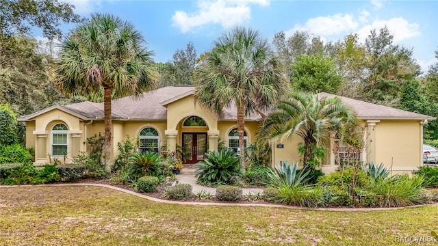 view of front of home featuring french doors and a front yard