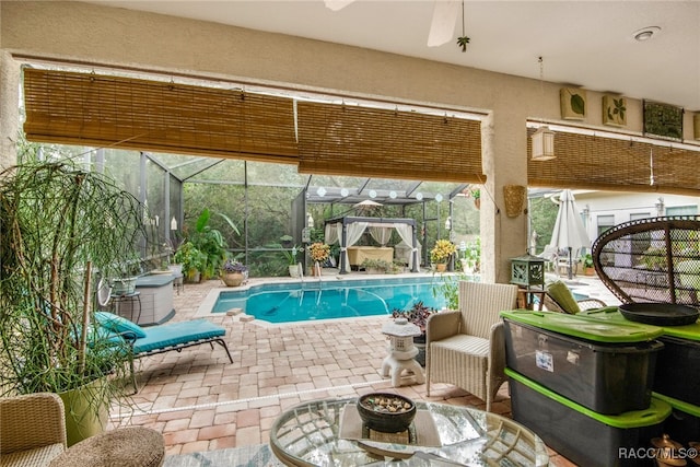 view of pool featuring a lanai, ceiling fan, and a patio