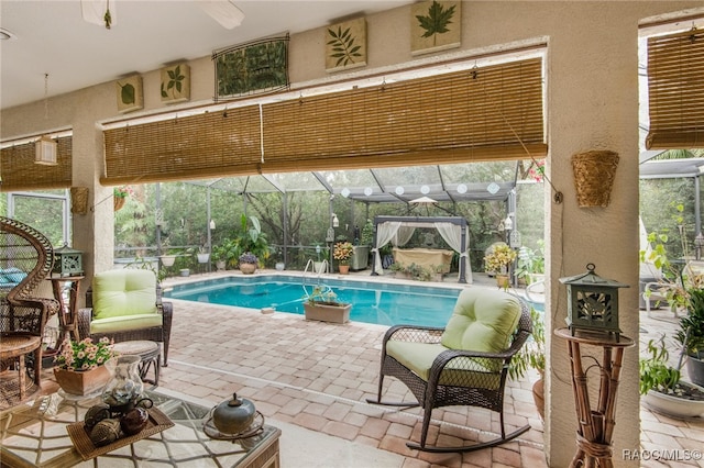 view of swimming pool with a patio and a lanai