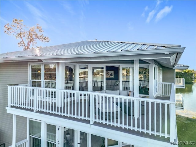 back of house with metal roof