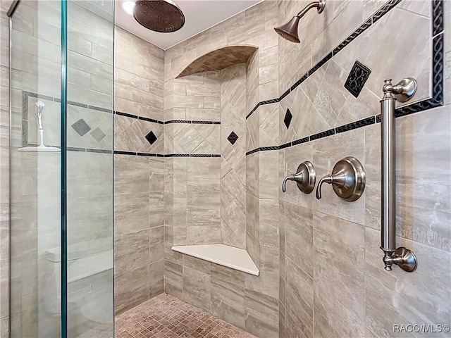 full bath featuring a tile shower