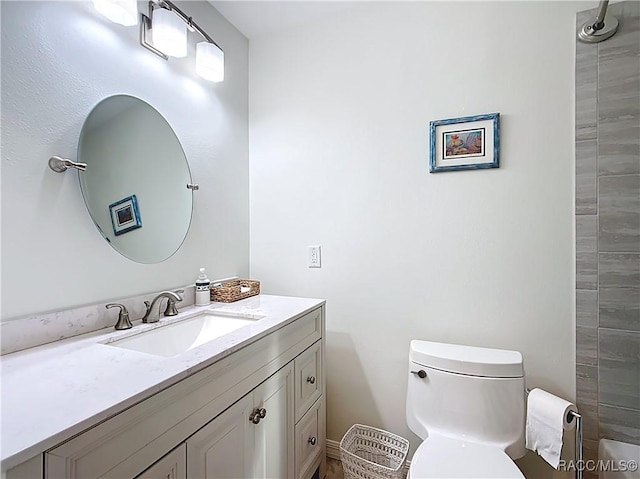 bathroom with toilet and vanity