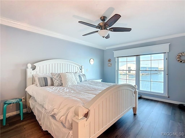 bedroom featuring crown molding, baseboards, dark wood-style flooring, and ceiling fan