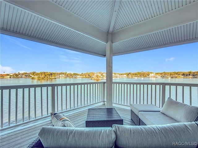 wooden deck featuring an outdoor hangout area and a water view