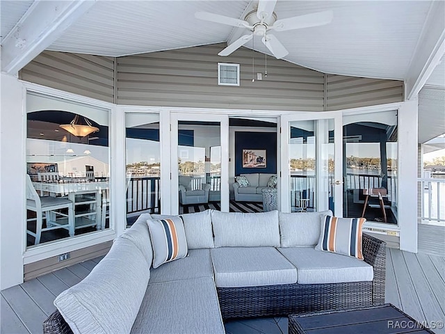 deck with an outdoor living space and a ceiling fan