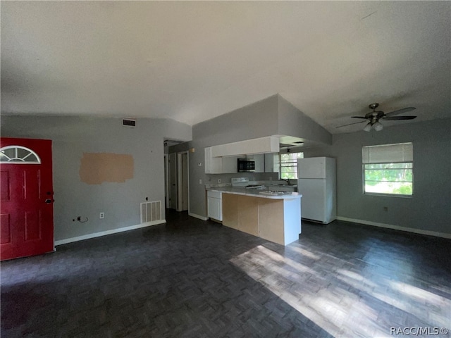 kitchen featuring vaulted ceiling, ceiling fan, white cabinets, and white appliances