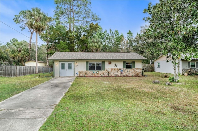 single story home featuring a front yard, stone siding, fence, and stucco siding