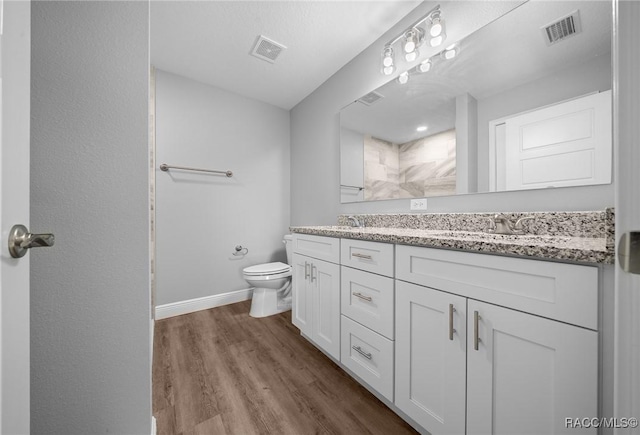 bathroom featuring hardwood / wood-style flooring, vanity, and toilet