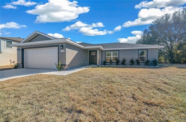 ranch-style house with a garage and a front lawn