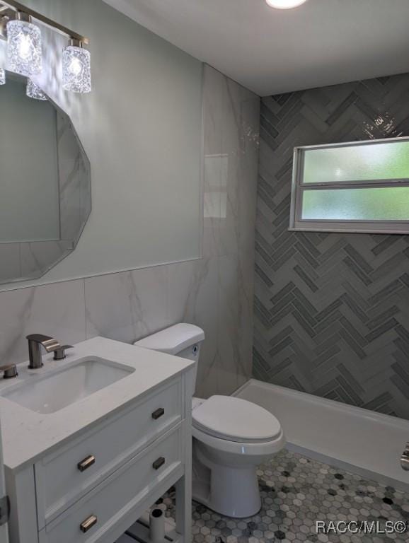 11 N Jefferson St, Beverly Hills, FL 34465 - full bathroom featuring vanity, tile walls, tiled shower, and tile patterned flooring