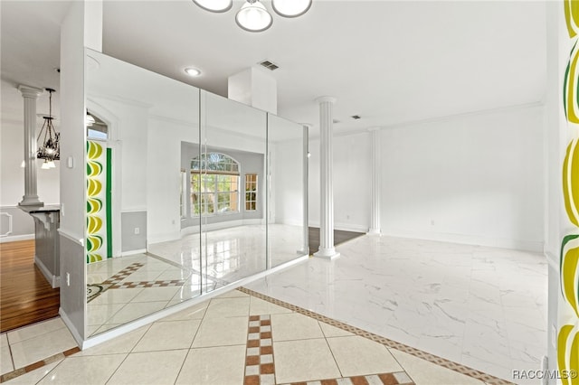 interior space with light tile patterned floors and decorative columns