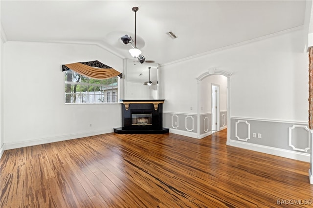 unfurnished living room featuring crown molding, lofted ceiling, and hardwood / wood-style floors