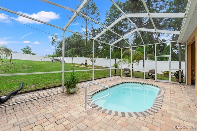 view of pool featuring a patio area, a lanai, and a lawn