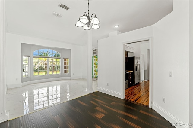 unfurnished dining area featuring a notable chandelier