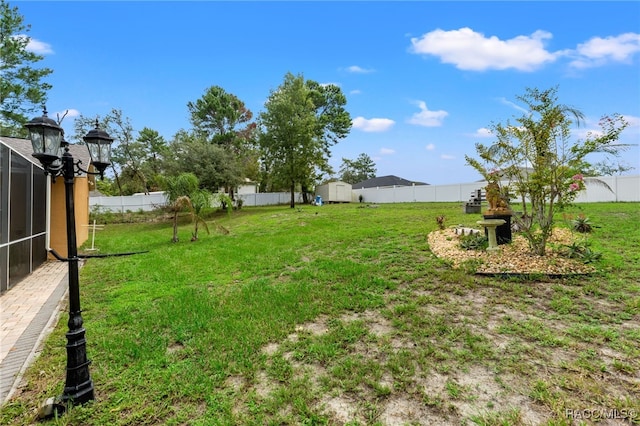 view of yard featuring a storage unit