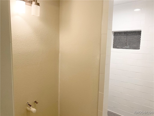 bathroom with a tile shower