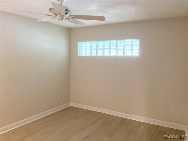 unfurnished room featuring hardwood / wood-style floors and ceiling fan