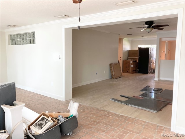 living room with hardwood / wood-style flooring, ceiling fan, and crown molding