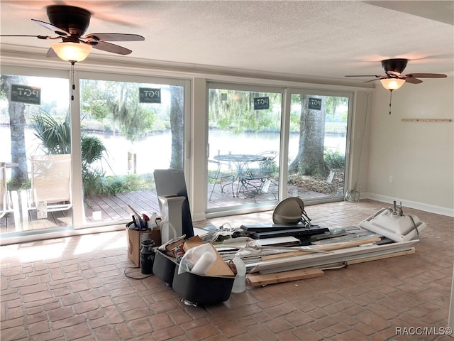 sunroom with ceiling fan and plenty of natural light