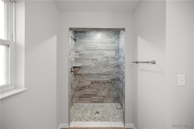 bathroom with a tile shower