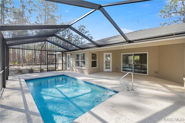 view of swimming pool featuring a lanai and a patio