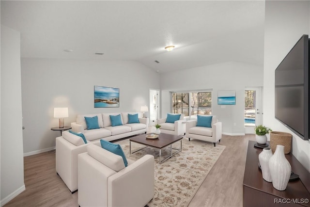 living room with lofted ceiling and light wood-type flooring