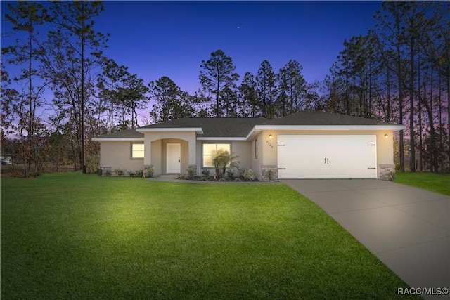 view of front of home featuring a lawn and a garage