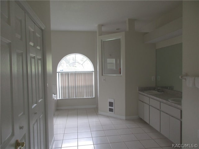 bathroom featuring tile patterned flooring and vanity