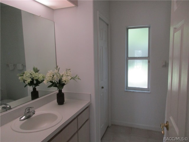 bathroom with tile patterned flooring and vanity