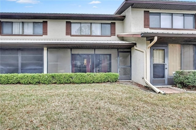 rear view of house featuring a lawn