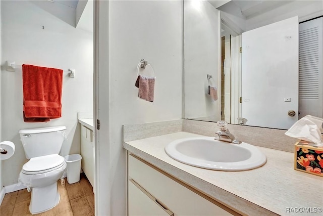 bathroom with vanity, toilet, and hardwood / wood-style floors