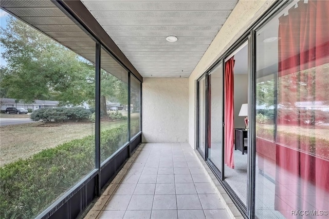 unfurnished sunroom featuring a wealth of natural light