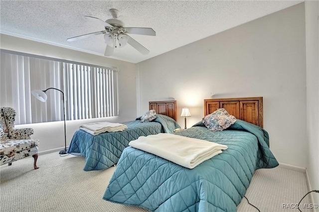 carpeted bedroom featuring a textured ceiling and ceiling fan