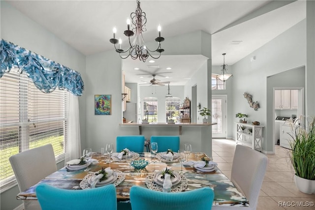 dining room featuring separate washer and dryer, light tile patterned flooring, and a notable chandelier