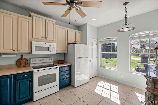 kitchen with light tile patterned floors, light countertops, white appliances, and hanging light fixtures