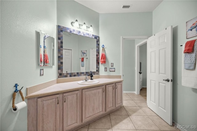 bathroom featuring tile patterned flooring, visible vents, and vanity