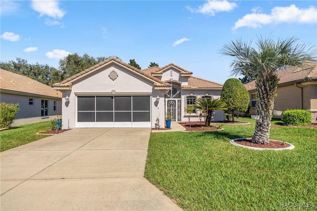 mediterranean / spanish-style house with a garage, a front yard, concrete driveway, and stucco siding