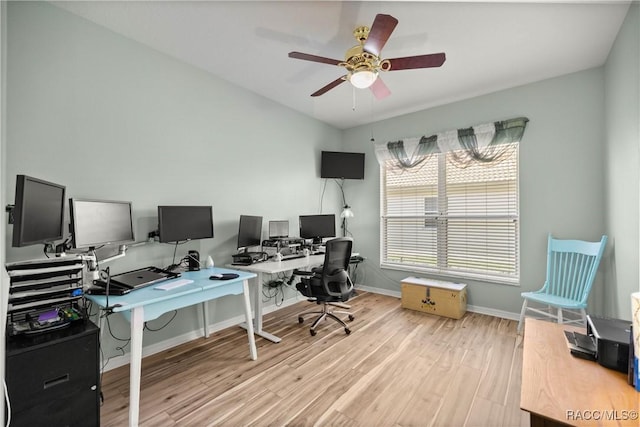 office featuring a ceiling fan, baseboards, and light wood finished floors