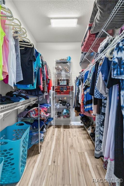 spacious closet with wood finished floors