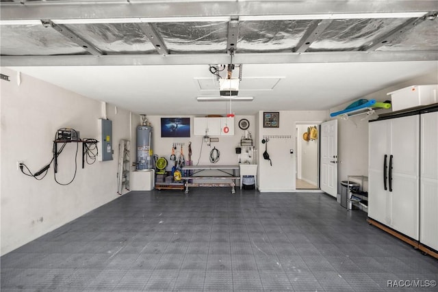 garage with a garage door opener, electric panel, and water heater